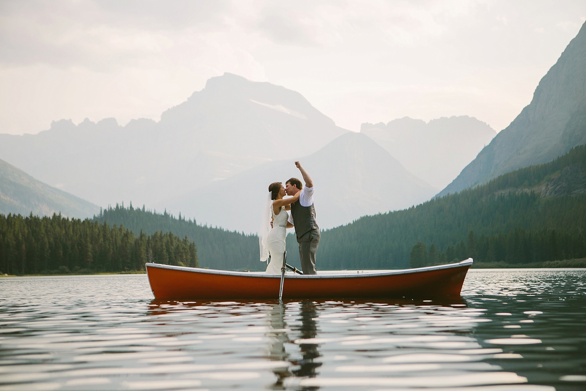 Glacier National Park MT Elopement Couple Kissing in a Canoe