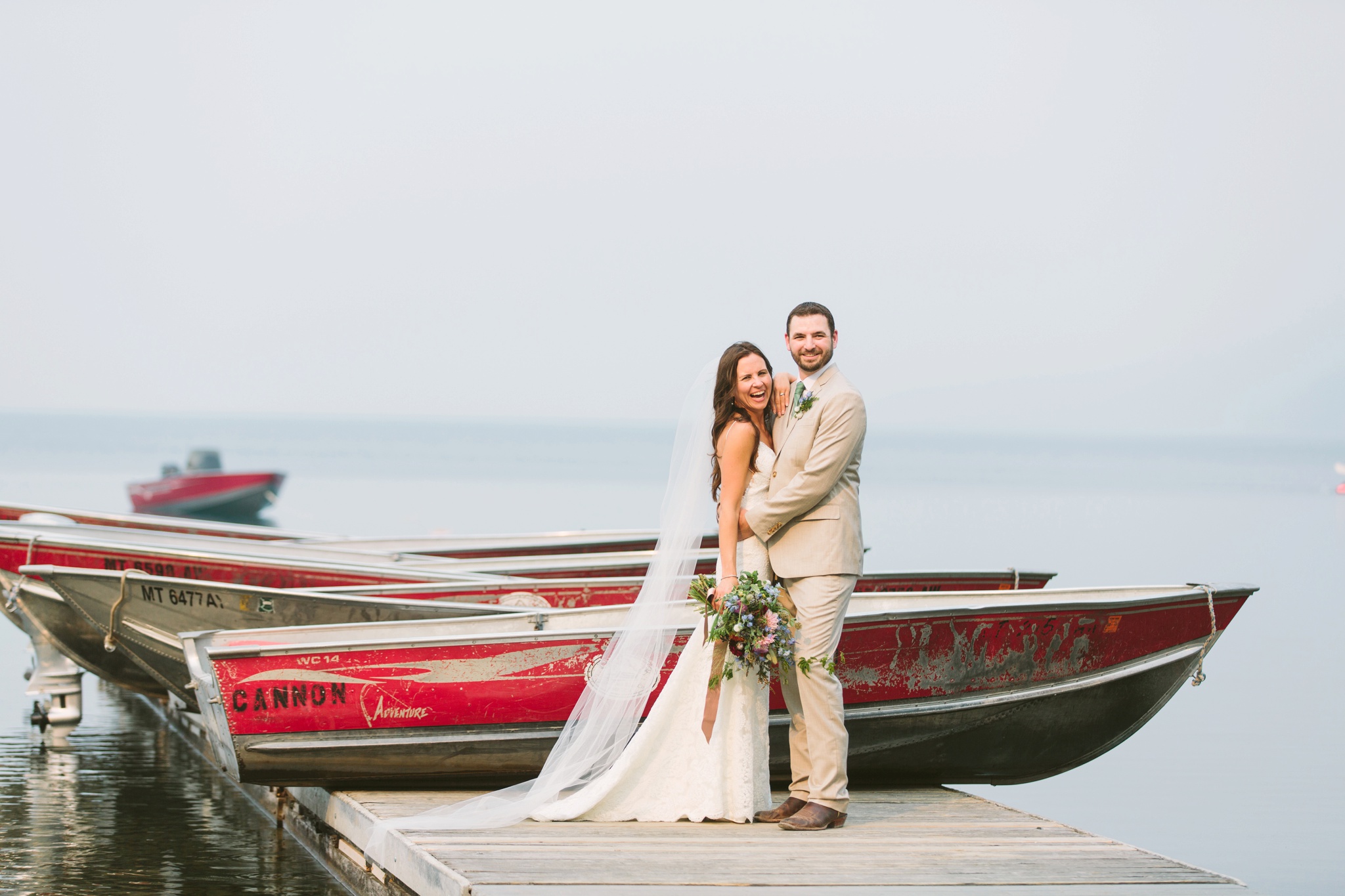 Glacier National Park Wildfire Wedding Couple on Lake McDonald Dock Laughing
