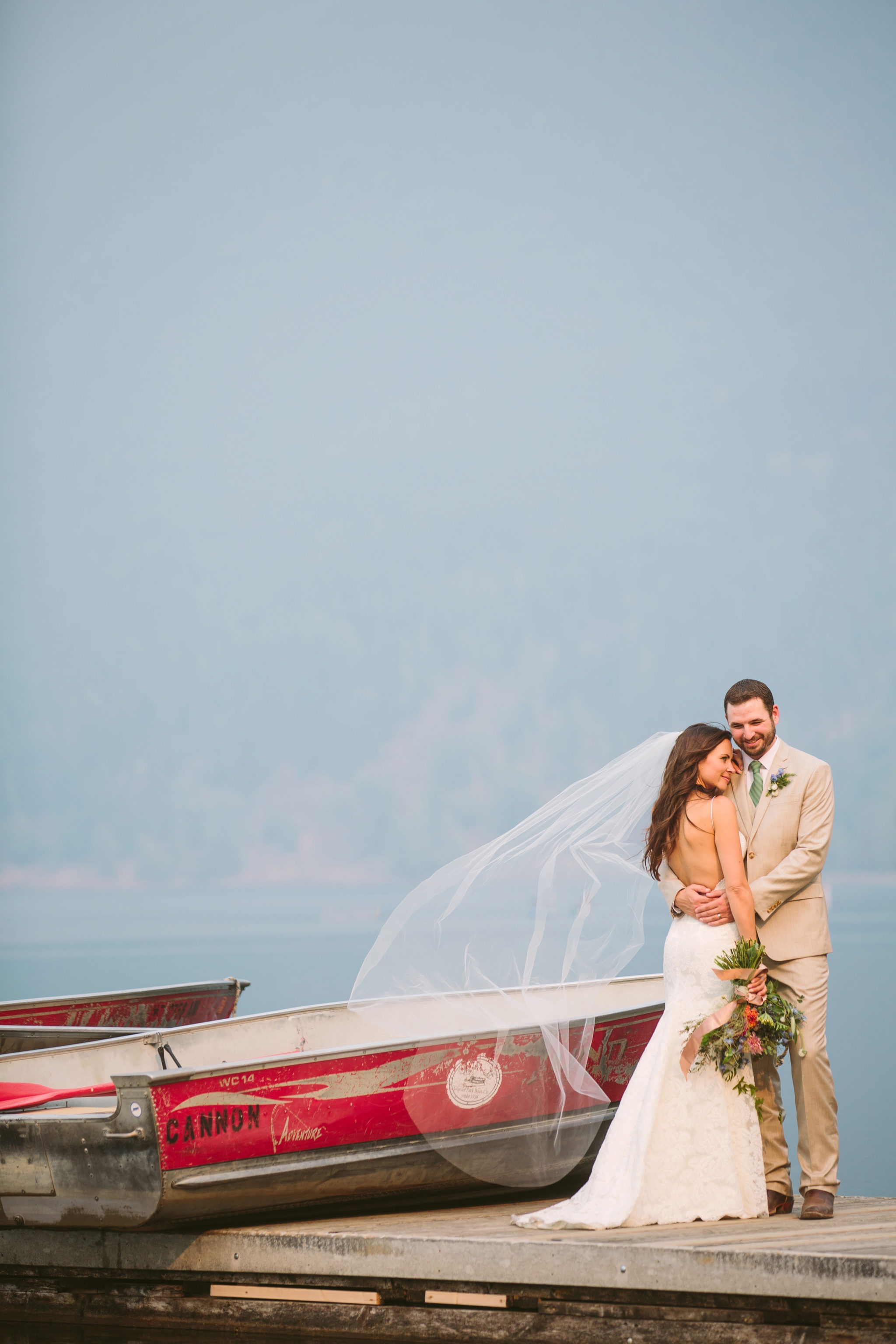 Glacier National Park Wildfire Wedding Couple on Lake McDonald Dock Hugging