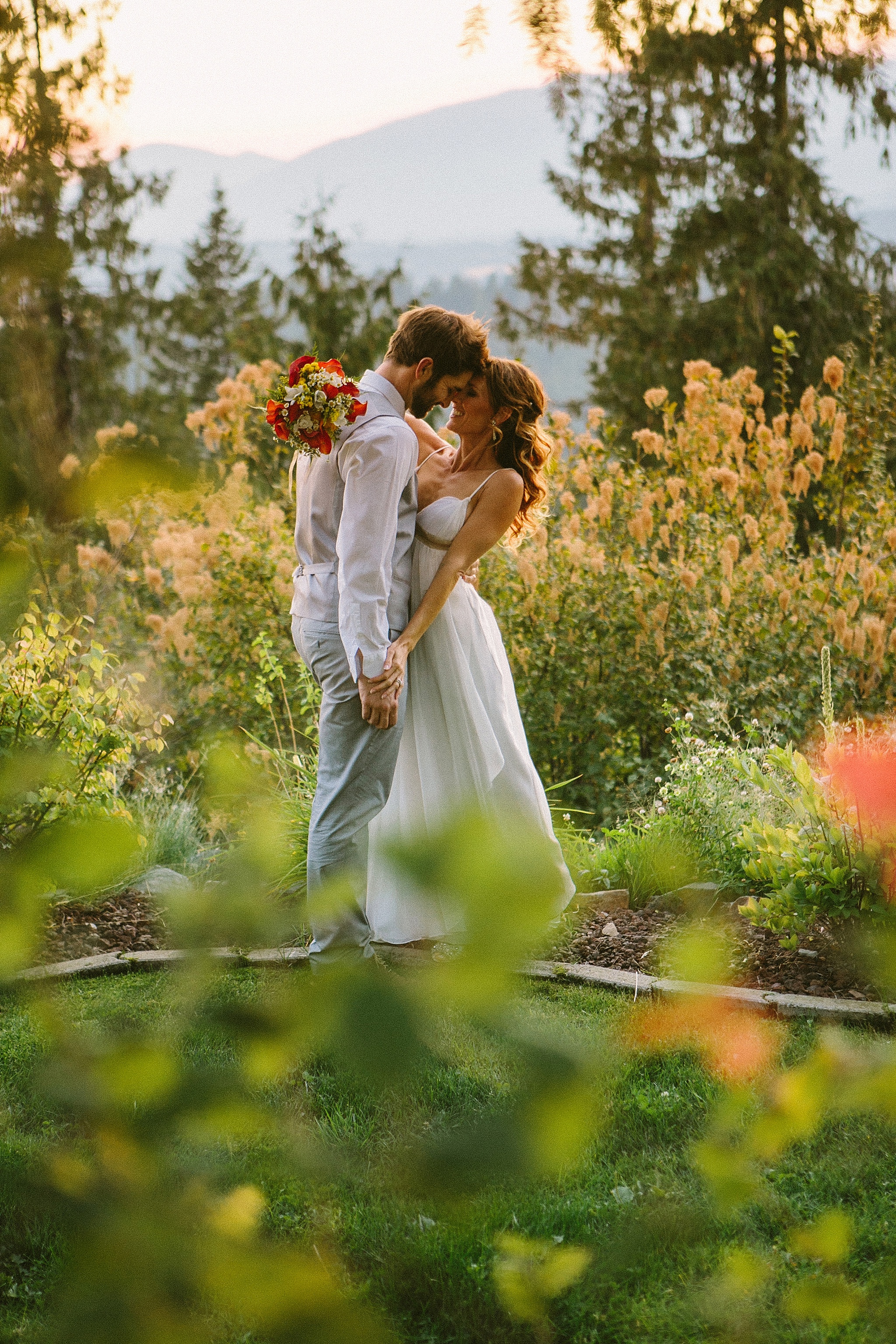 Sandpoint Idaho golf course wedding photo couple holding hands laughing in the garden