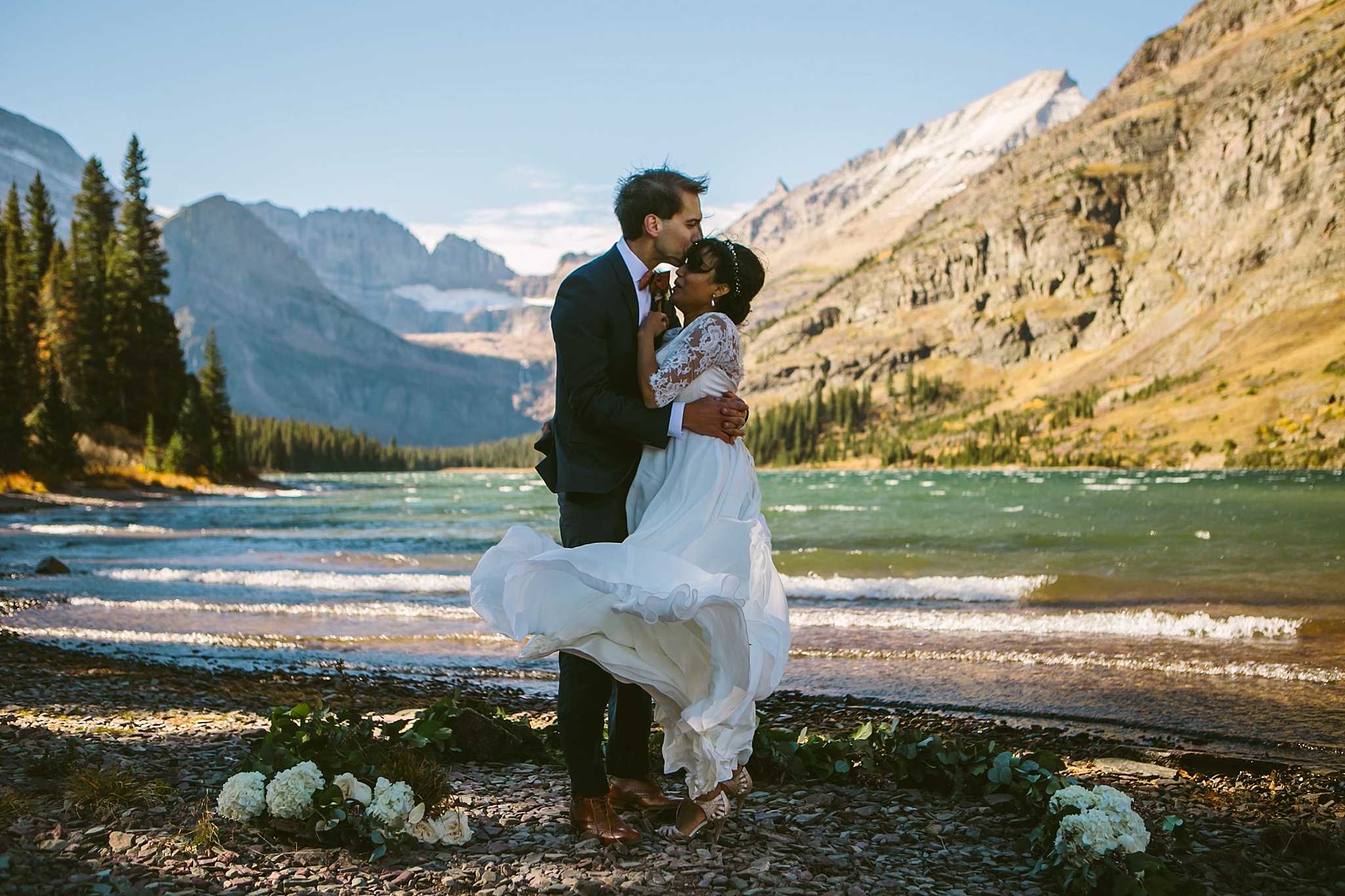 Josephine Lake Glacier National Park Elopement Ceremony Couple Hugging in the Wind