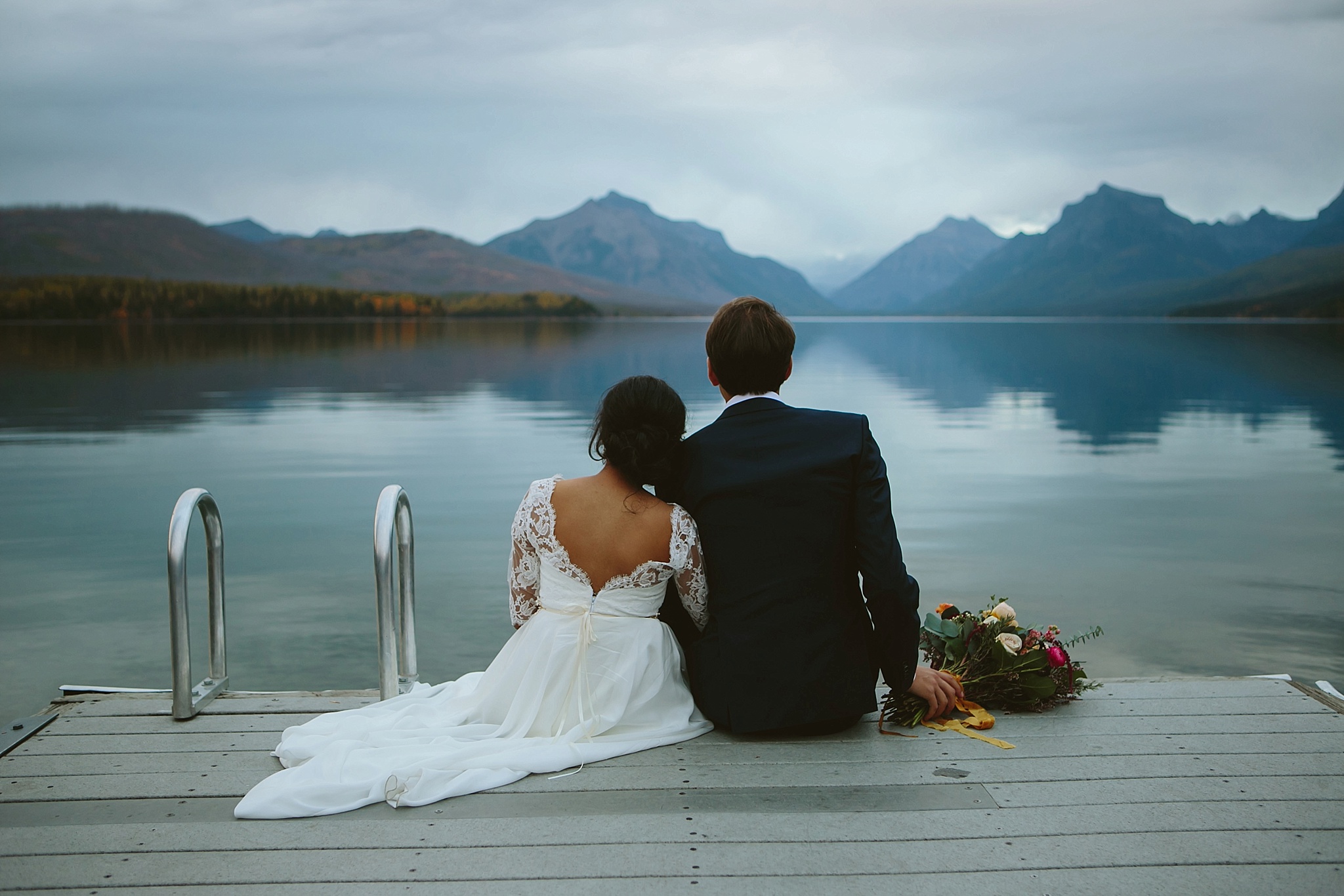 Glacier National Park Wedding Photos Couple Sitting on the Dock at Lake McDonald