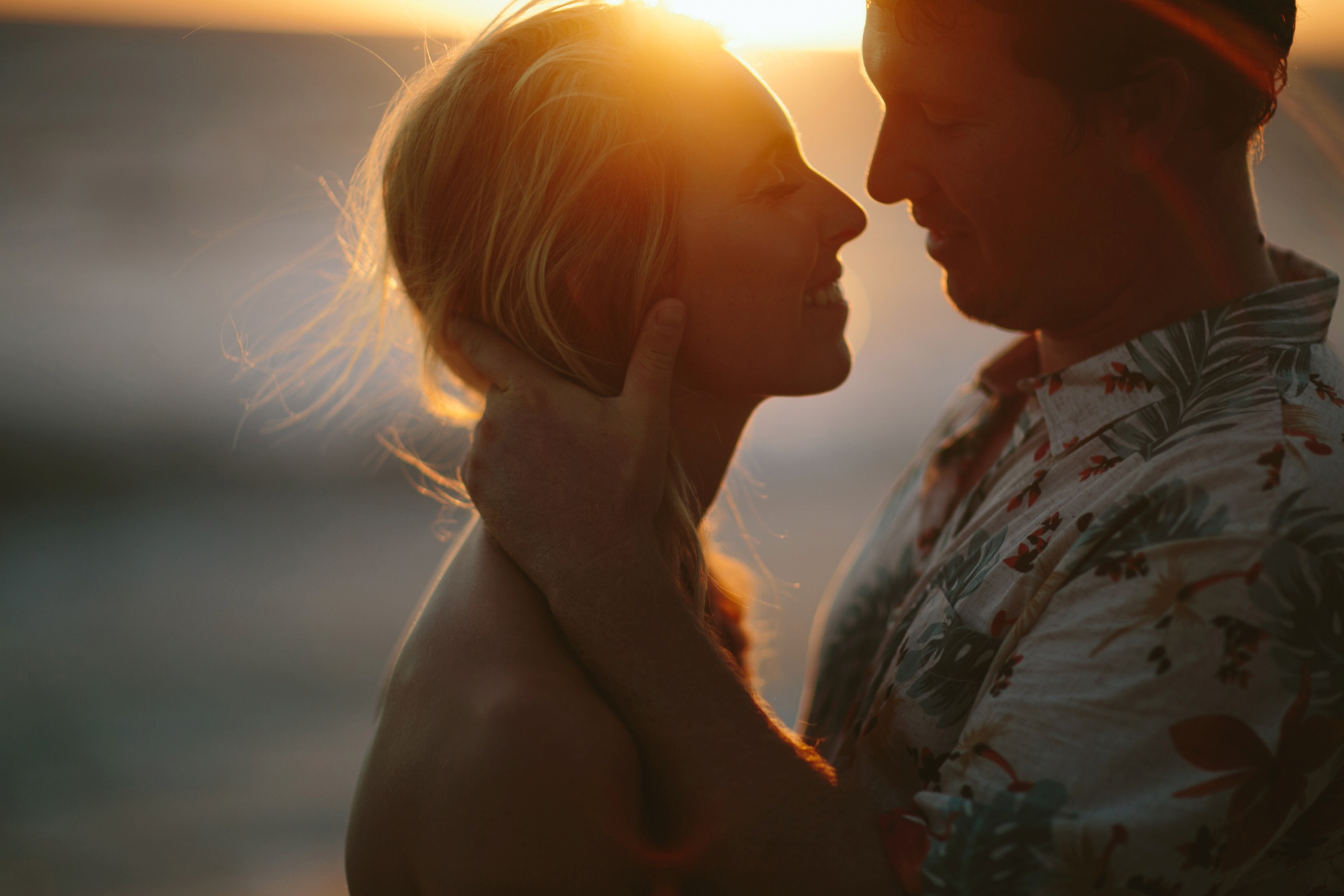 Kauai HI Beach Engagement Photos Couple Kissing at Sunset