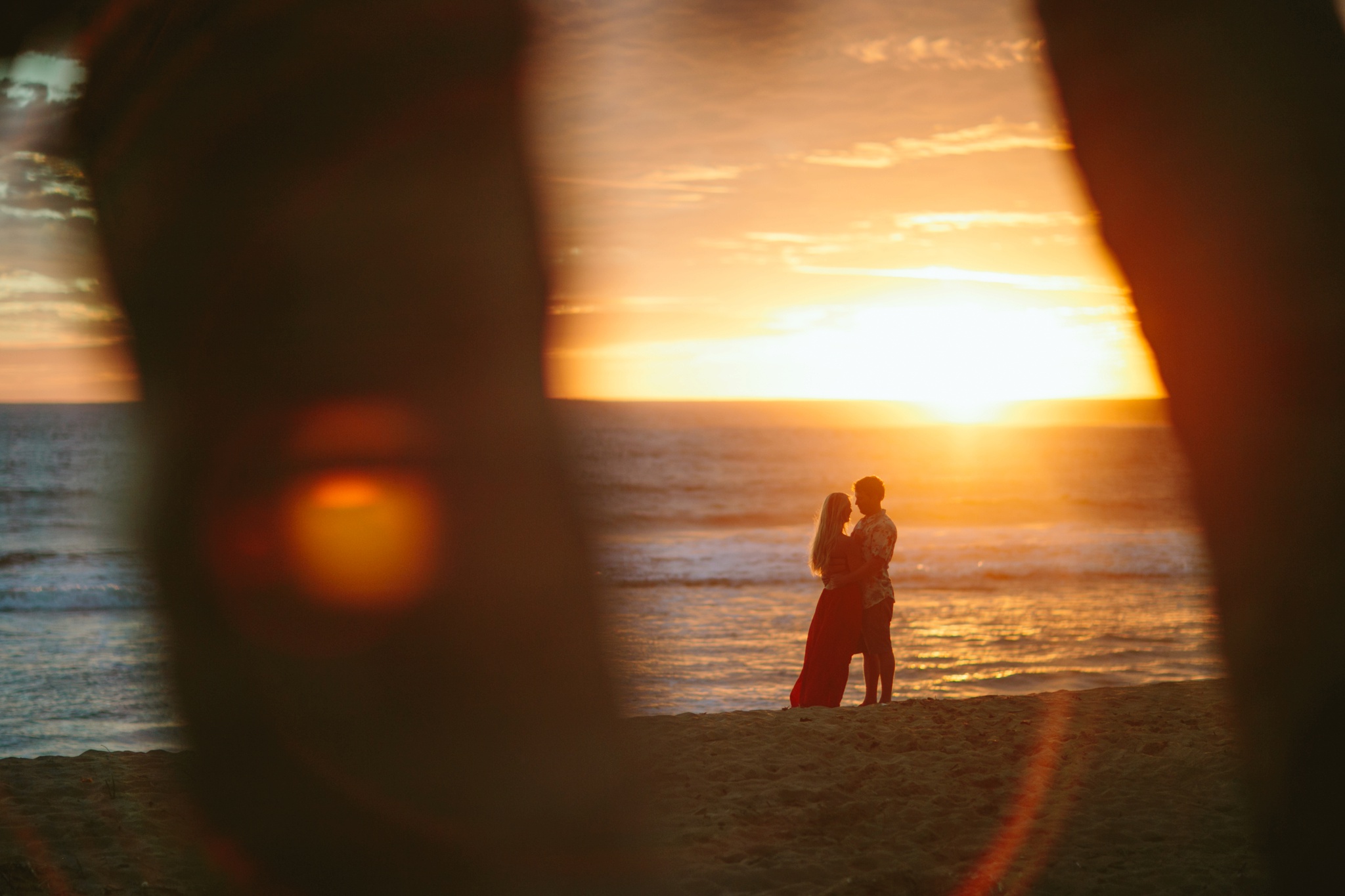 Kauai HI Beach Engagement Photos Couple Hugging at Sunset