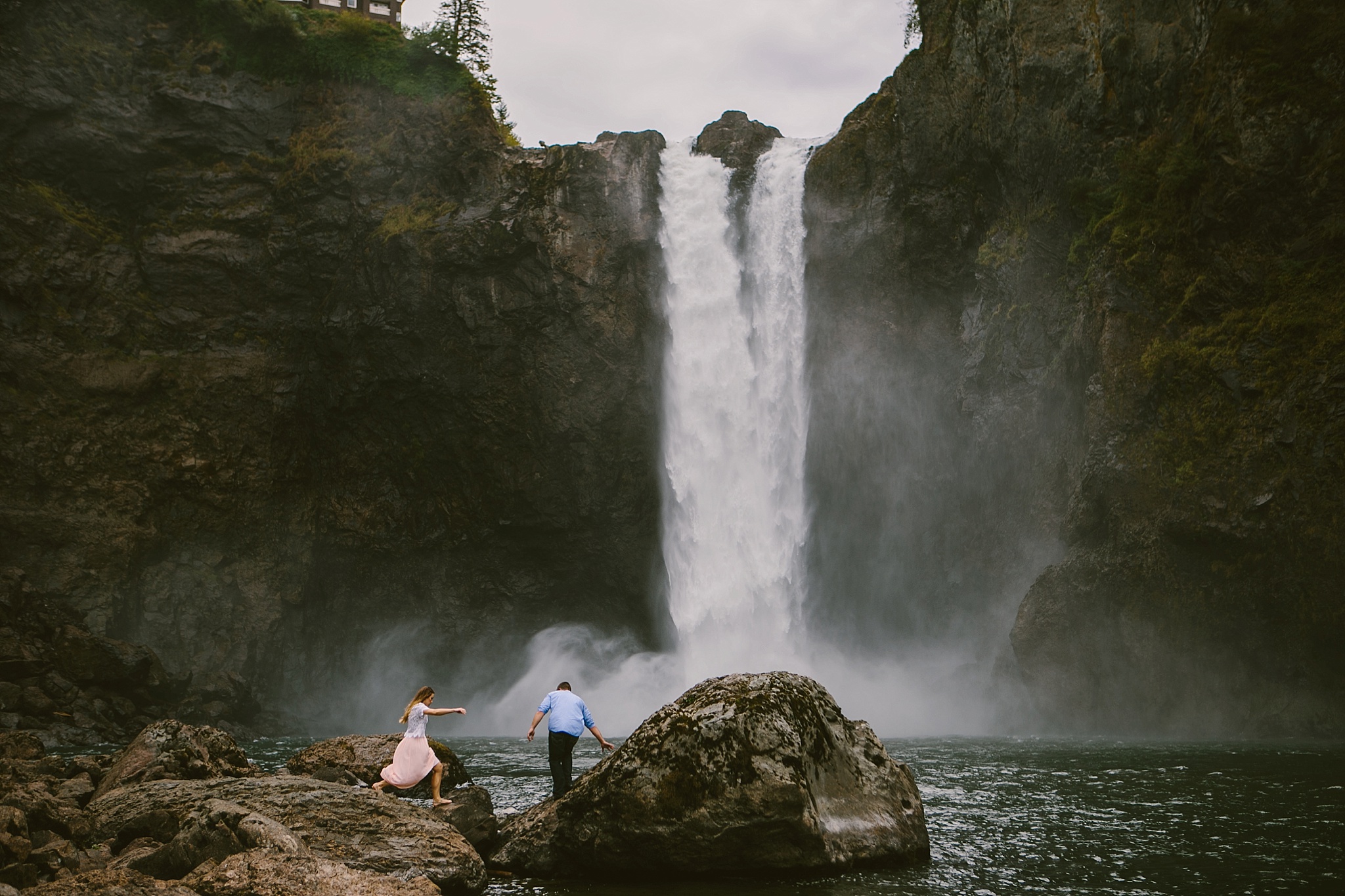 Seattle WA Engagement Photos Bride and Groom Climbing Rocks at Snoqualmie Falls