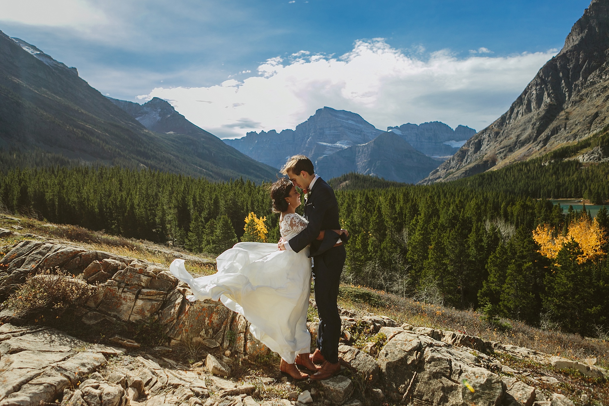 Many Glacier National Park Intimate Wedding Photos Bride and Groom Huggin in the Wind