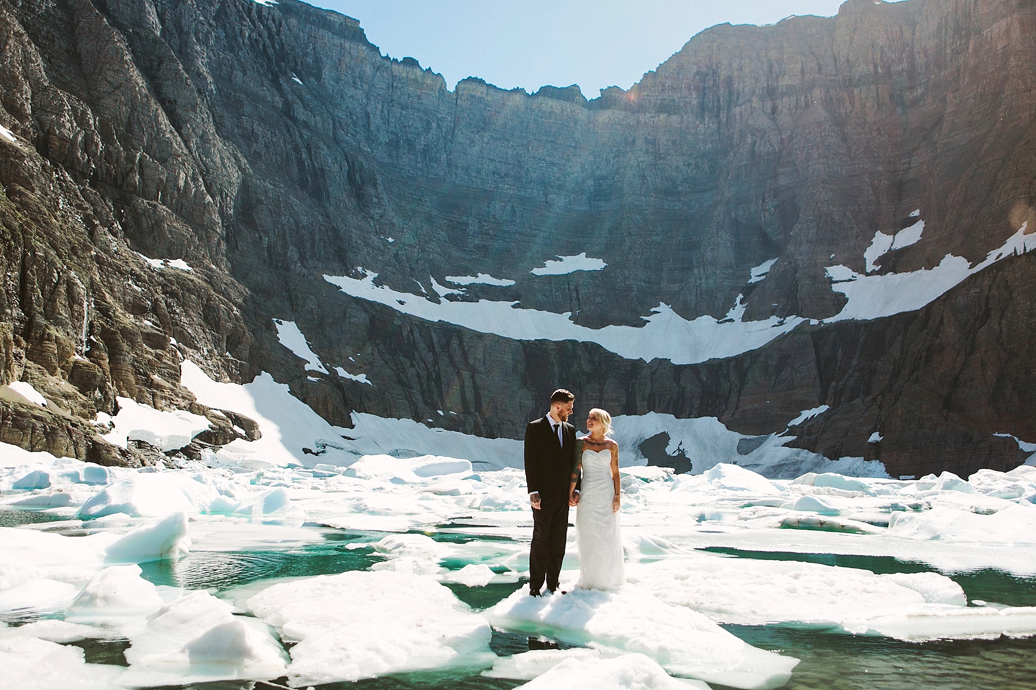 Glacier National Park Elopement Photos Bride and Groom on Iceberg at Iceberg Lake