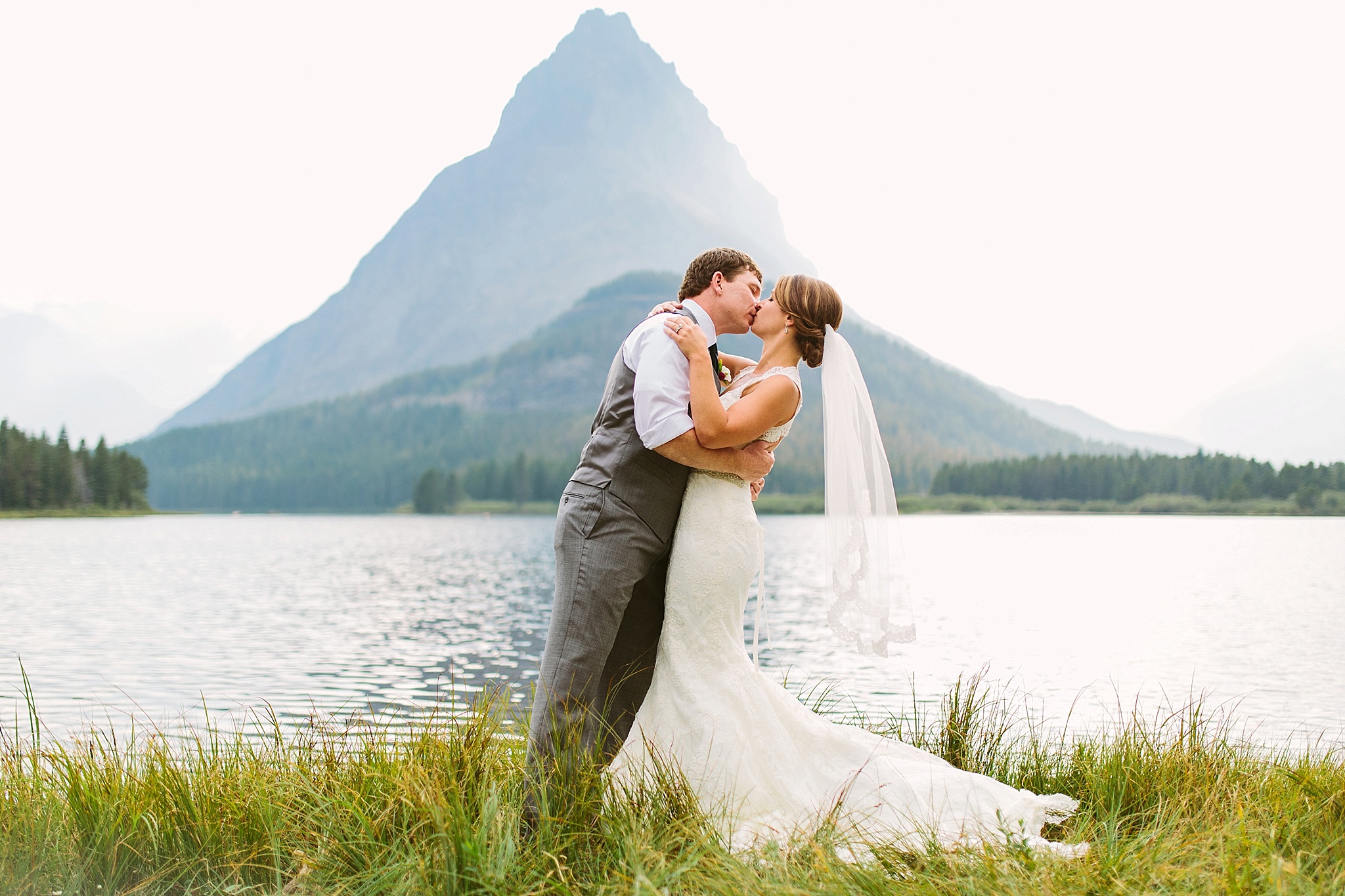 Many Glacier National Park Elopement Photos Bride and Groom Kissing by the Lake