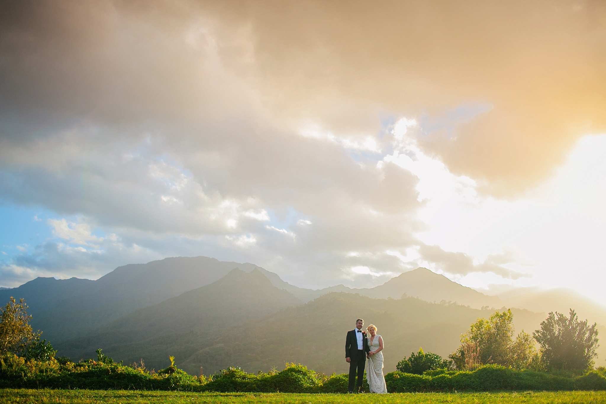 Hanalei Kauai HI Wedding Photos Bride and Groom Holding Hands at Sunset