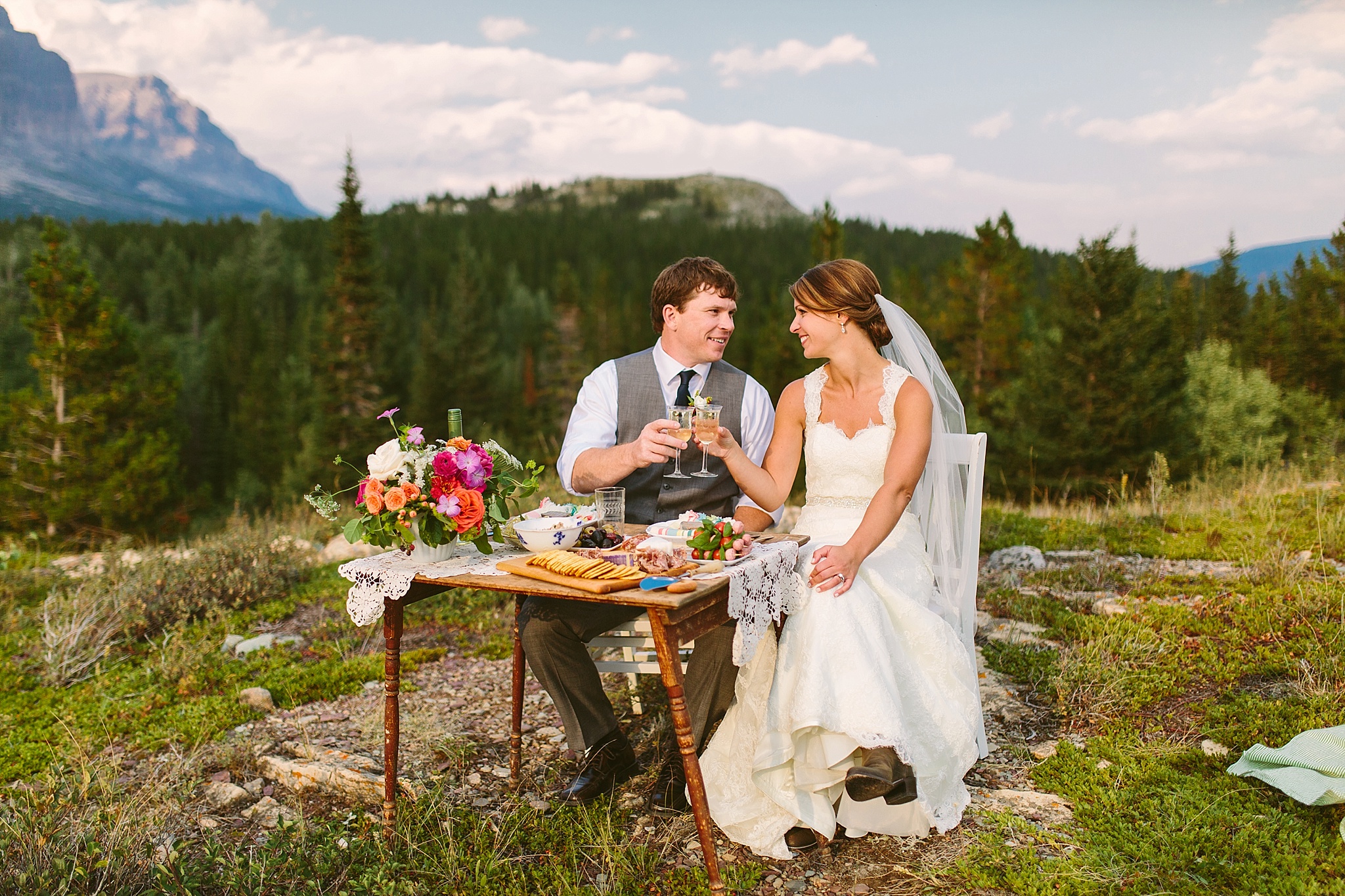 Many Glacier National Park Elopement Photos Bride and Groom Sharing a Picnic for Two on a Mountaintop