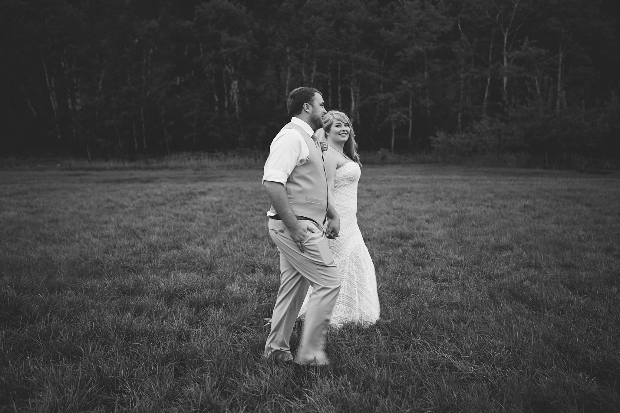Arrowpeak Lodge Great Falls MT Wedding Photos Bride and Groom Walking Holding Hands