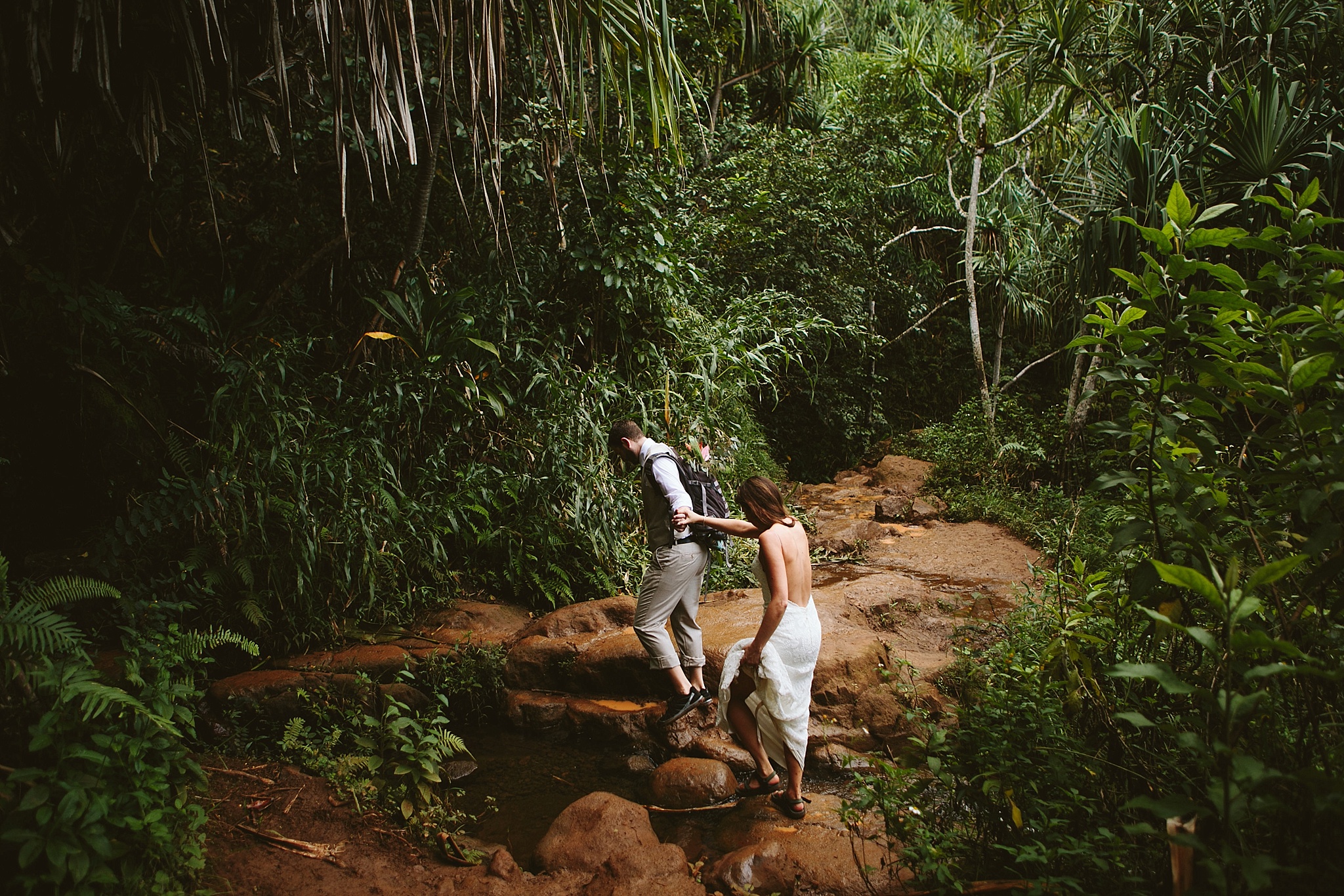 Kalalau Trail Kauai HI Elopement Photos Bride and Groom Holding Hands Hiking