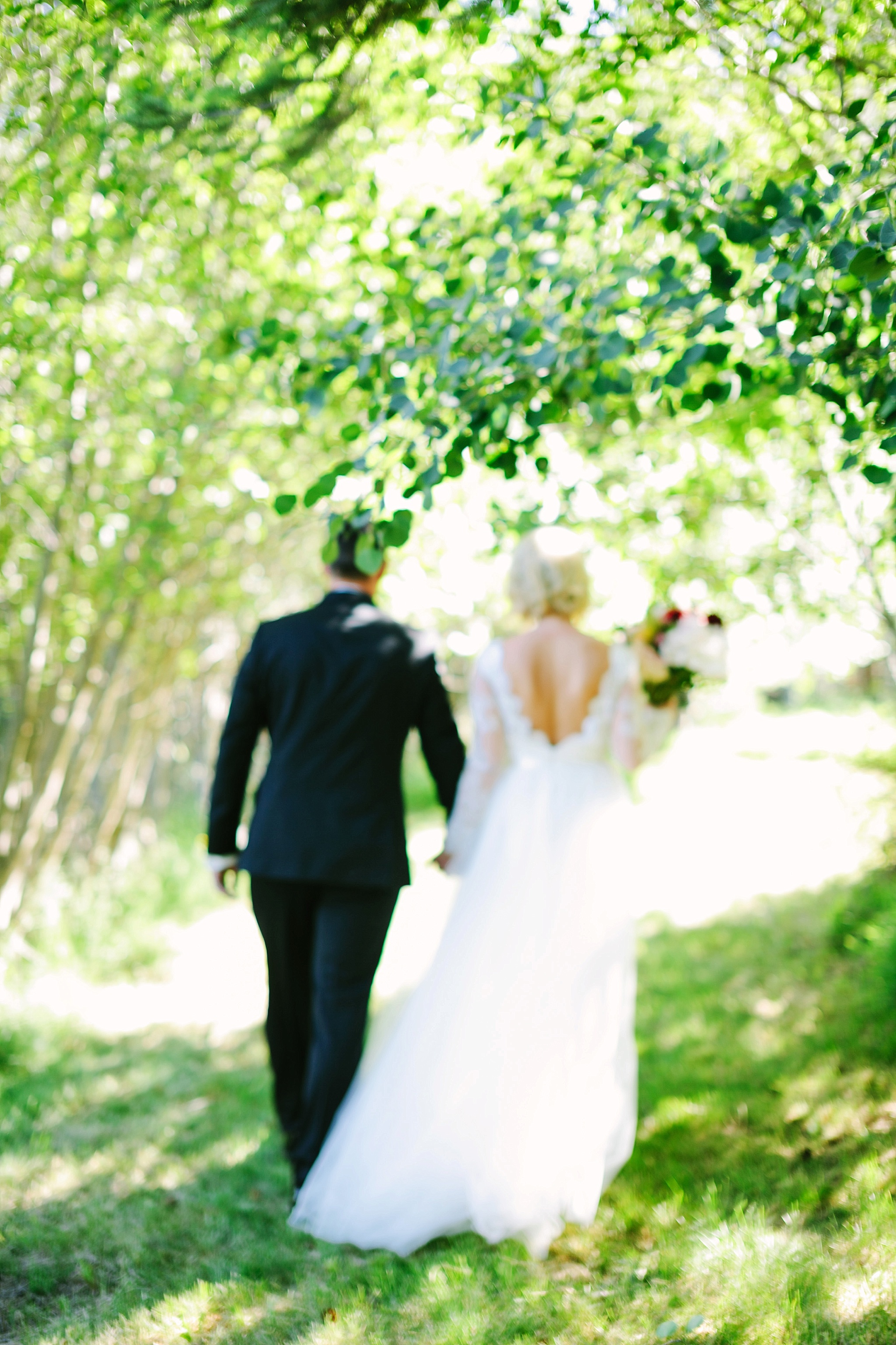 Missoula MT Backyard Wedding Photos Bride and Groom Walking Holding Hands