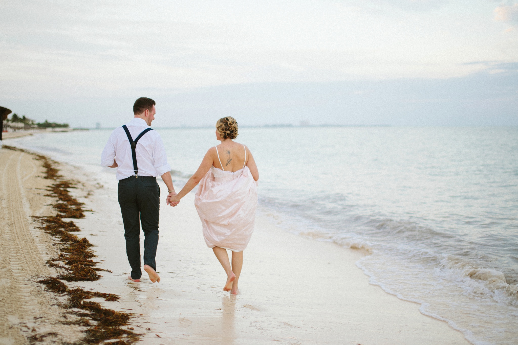 Moon Palace Resort Cancun Mexico Wedding Photos Bride and Groom Holding Hands Walking on the Beach