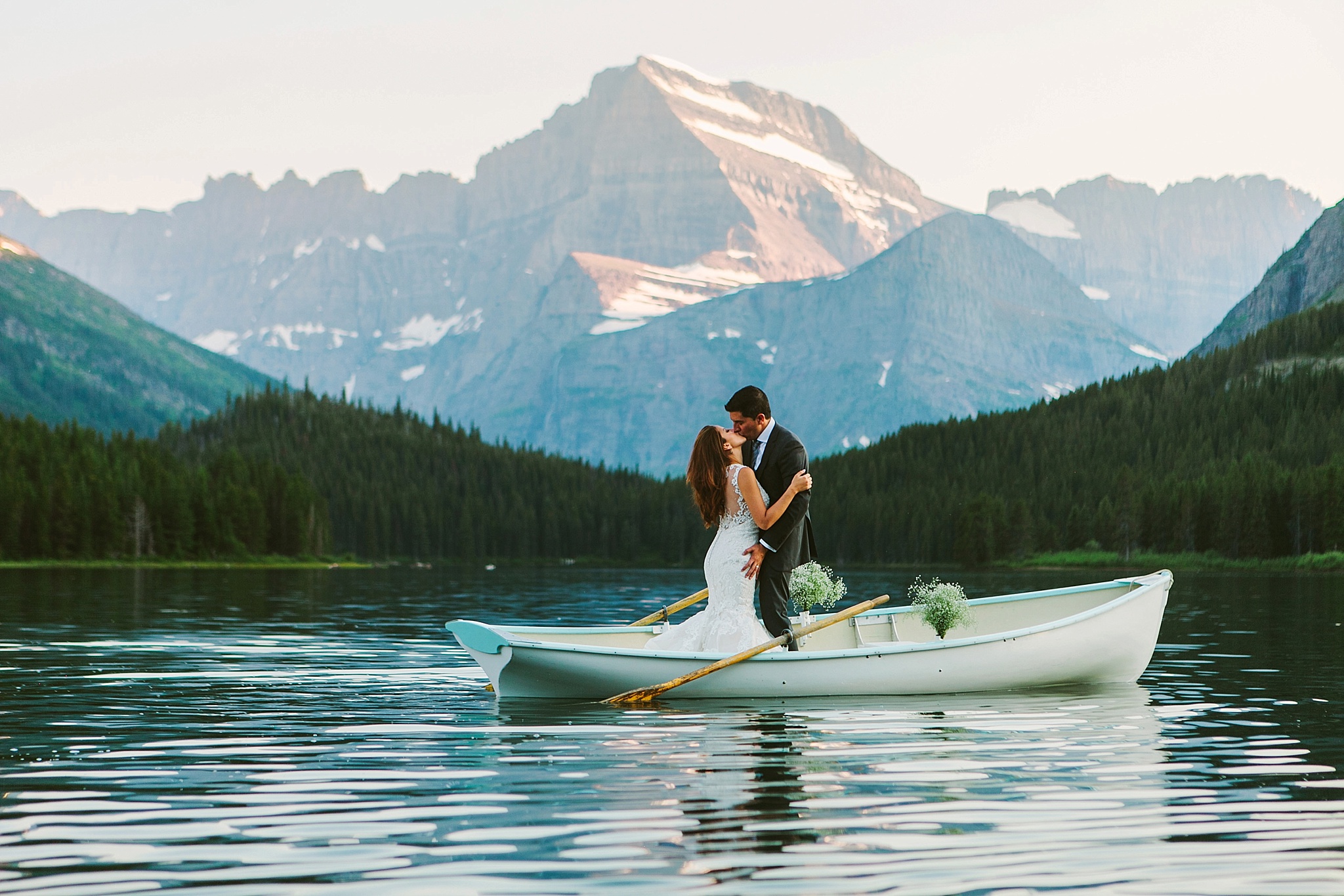 Many Glacier National Park Wedding Photos Bride and Groom in Boat on Lake Kissing