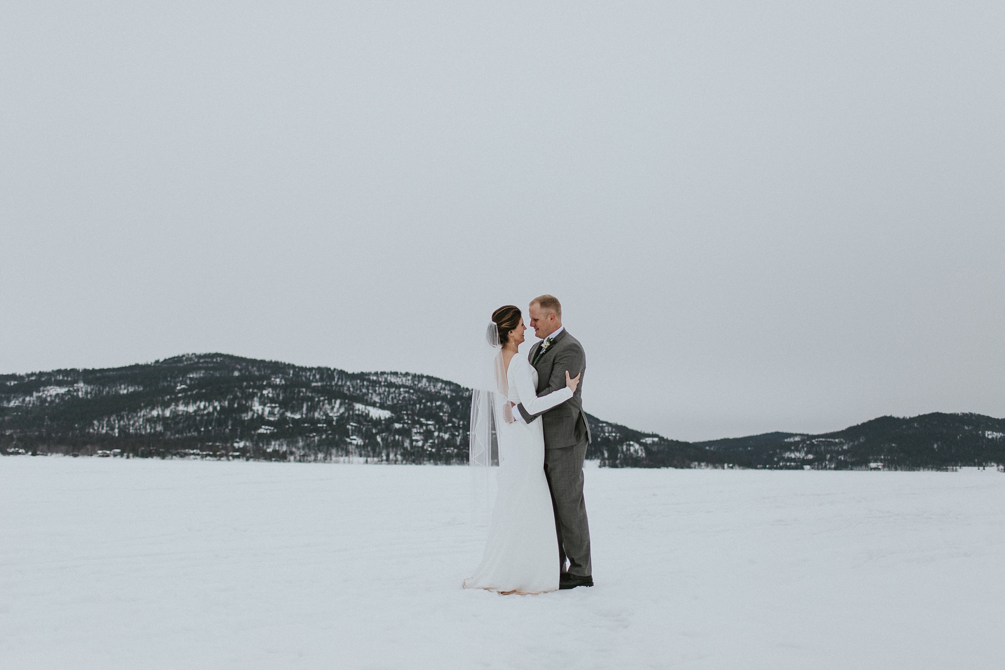 Whitefish Lake MT Winter Wedding Couple Embracing 