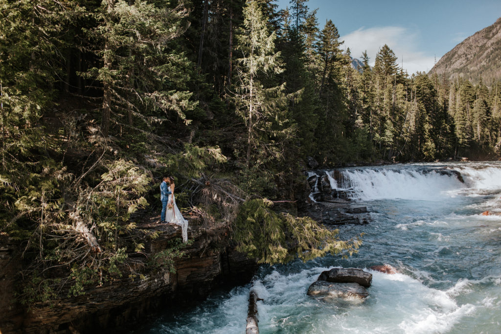 Early summer elopement in Glacier National Park at a waterfall