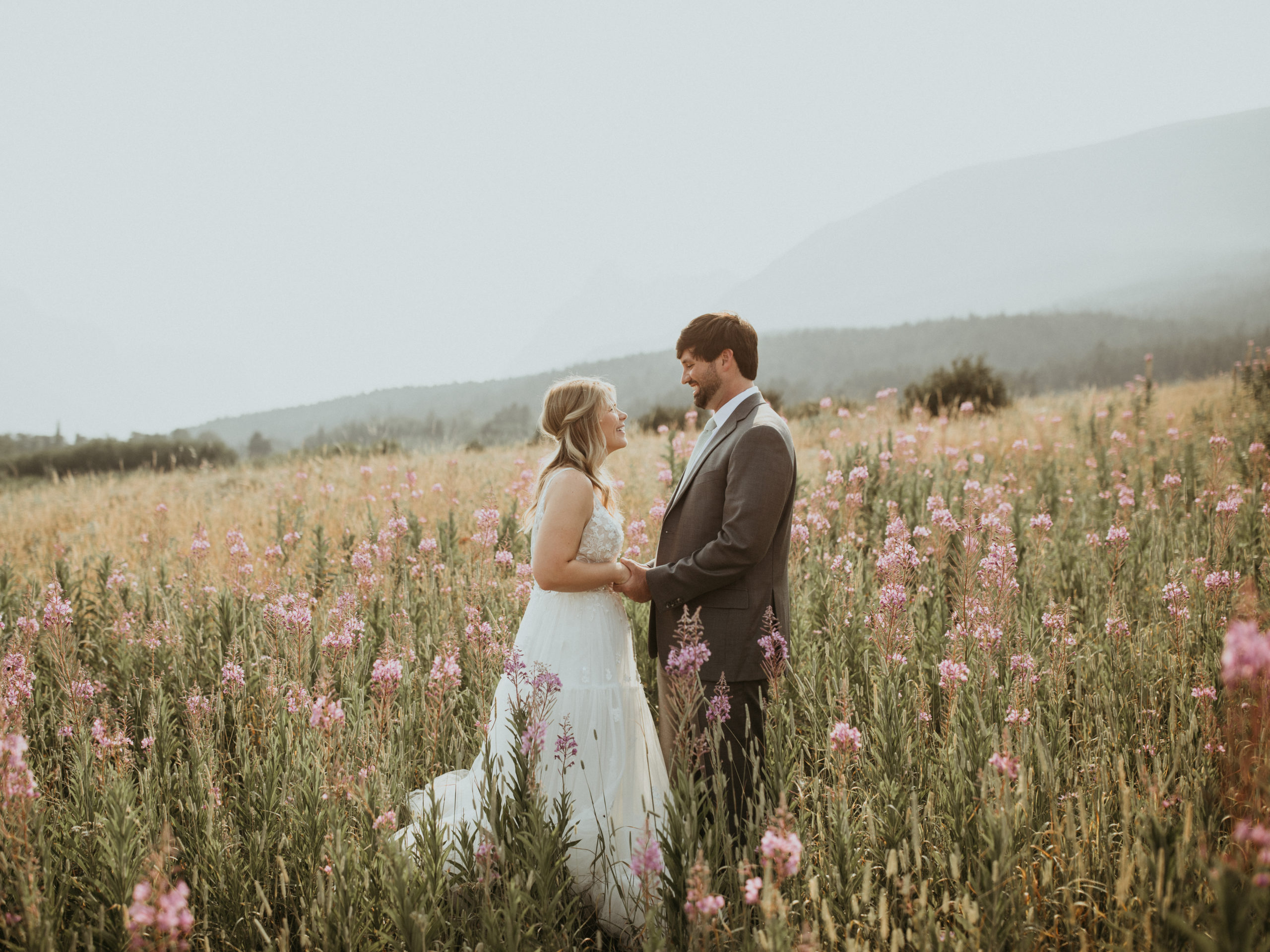 Bride and Groom in wildflower field of Glacier National Park