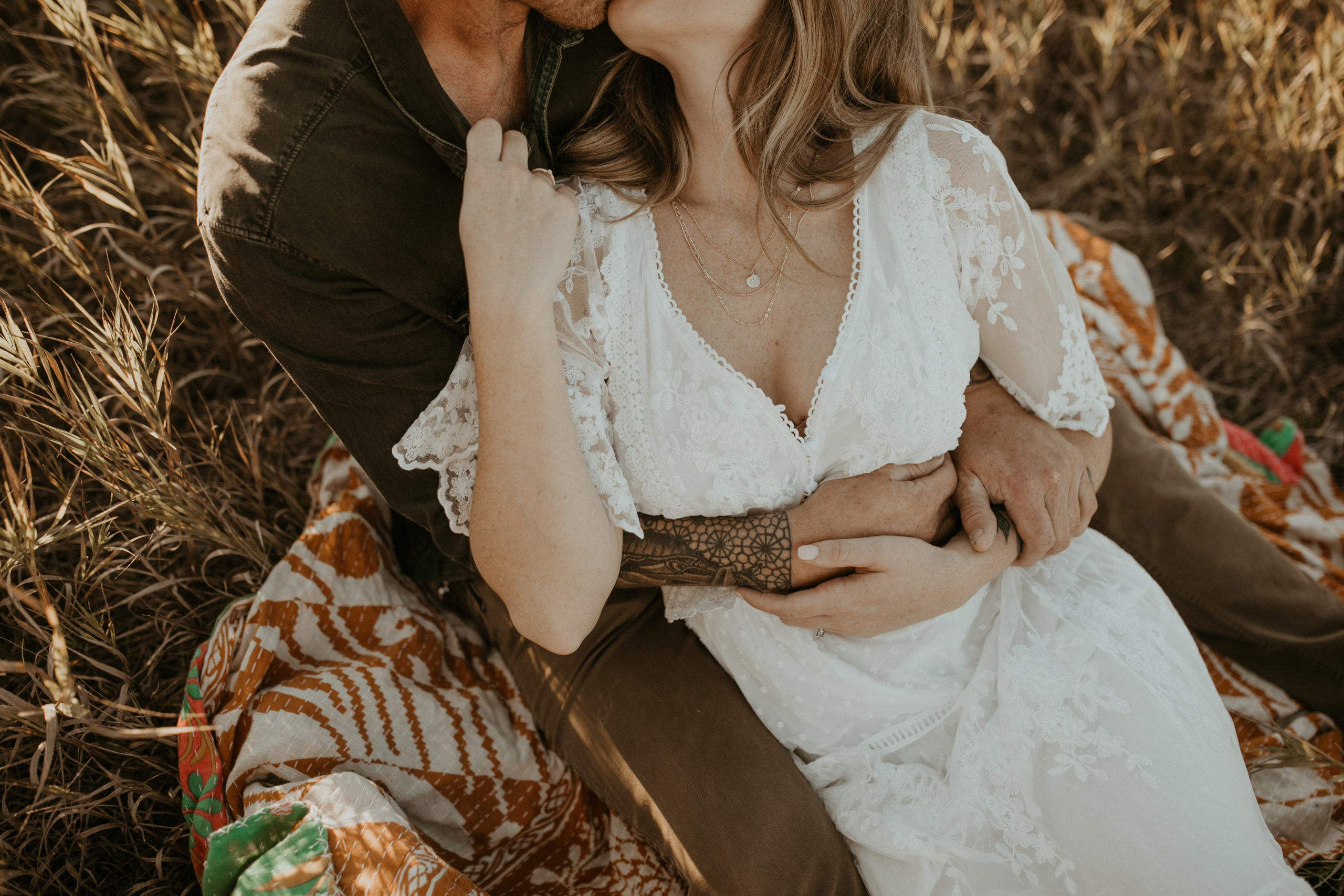 Couple embraces in the dreamy sunshine of a golden summer engagement photos