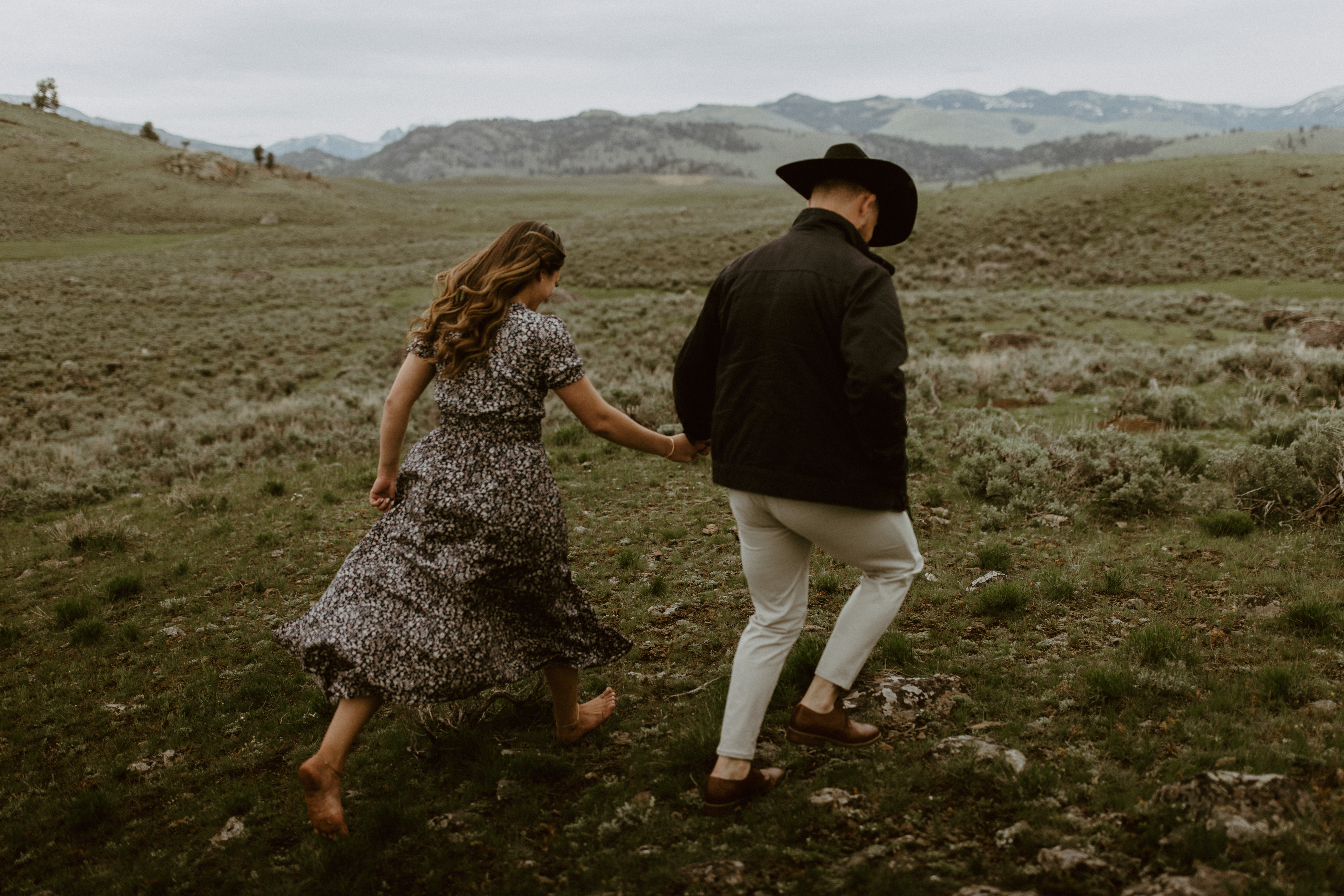Bride and groom run barefoot through Yellowstone National Park