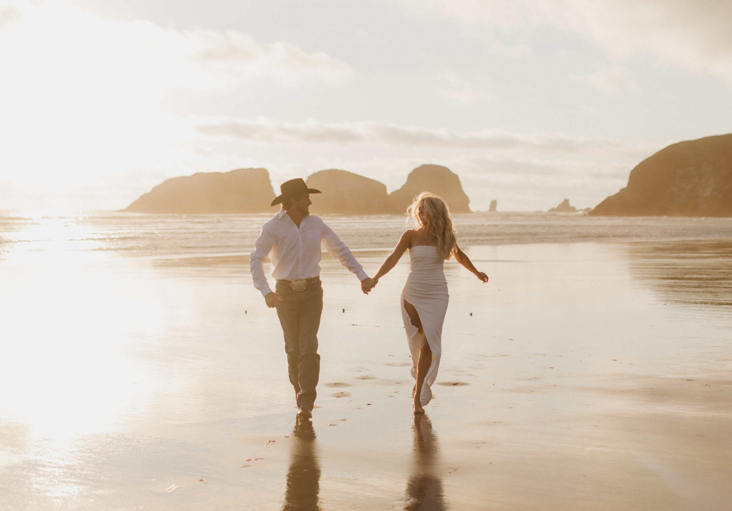 Elopement couple running on the beach at Cannon Beach
